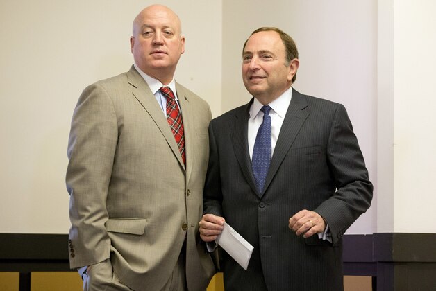 FILE - In this Dec. 9, 2014, file photo, NHL hockey commissioner Gary Bettman, right, and deputy commissioner Bill Daly pause before starting a news conference after attending an NHL owners meeting in Boca Raton, Fla. Bill Foley is trying to bring an NHL expansion team to Las Vegas, and so far he's marching in step with Commissioner Bettman. (AP Photo/Wilfredo Lee, File)