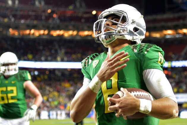 Dec 5, 2014; Santa Clara, CA, USA; Oregon Ducks quarterback Marcus Mariota (8) celebrates after scoring on a 7-yard touchdown run in the second quarter against the Arizona Wildcats in the Pac-12 Championship at Levi's Stadium. Mandatory Credit: Kirby Lee-USA TODAY Sports