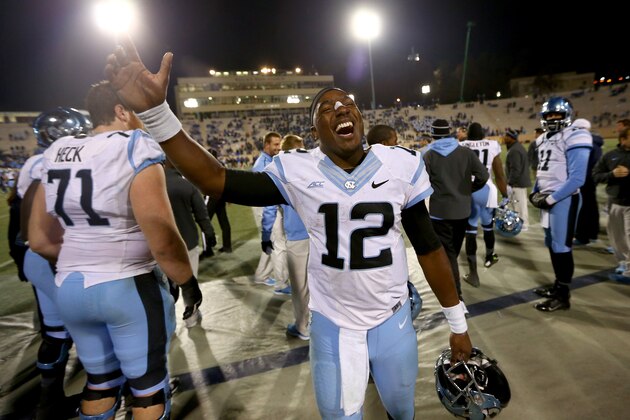 DURHAM, NC - NOVEMBER 20:  Marquise Williams #12 of the North Carolina Tar Heels celebrates after defeating the Duke Blue Devils 45-20 at Wallace Wade Stadium on November 20, 2014 in Durham, North Carolina.  (Photo by Streeter Lecka/Getty Images)
