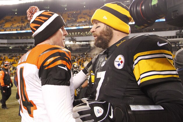 Dec 15, 2013; Pittsburgh, PA, USA; Cincinnati Bengals quarterback Andy Dalton (14) and Pittsburgh Steelers quarterback Ben Roethlisberger (7) shake hands after their game at Heinz Field. The Steelers won 30-20. Mandatory Credit: Charles LeClaire-USA TODAY Sports
