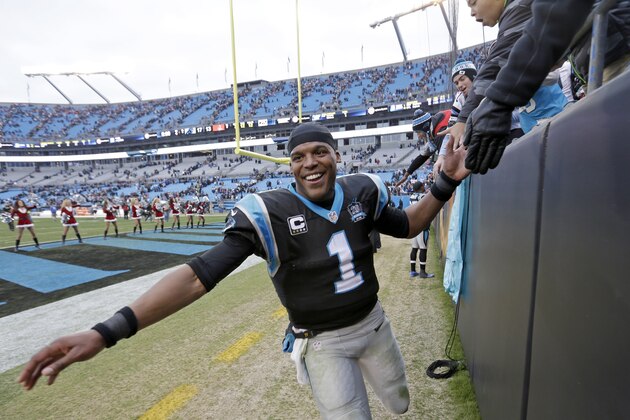 Carolina Panthers' Cam Newton celebrates his team's 17-13 win over the Cleveland Browns with fans in the stands after an NFL football game in Charlotte, N.C., Sunday, Dec. 21, 2014.  (AP Photo/Bob Leverone)