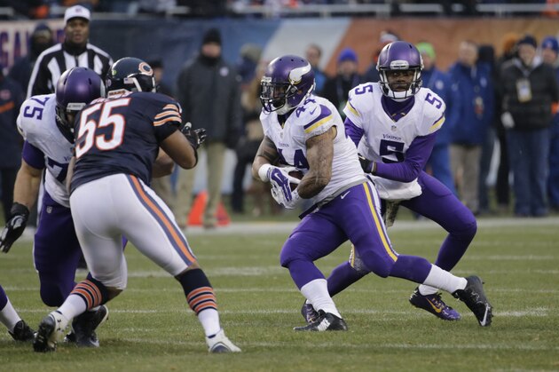 Minnesota Vikings running back Matt Asiata (44) takes a handoff from quarterback Teddy Bridgewater (5) during the second half of an NFL football game Sunday, Nov. 16, 2014 in Chicago. The Bears won 21-13. (AP Photo/Charles Rex Arbogast)