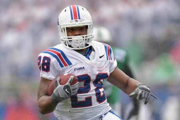 HUNTINGTON, WV - DECEMBER 06: Kenneth Dixon #28 of the Louisiana Tech Bulldogs carries the ball during the 2nd quarter against the Marshall Thundering Herd at Joan C. Edwards Stadium during the Conference USA championship game on December 6, 2014 in Huntington, West Virginia. The Thundering Herd defeated the Bulldogs 26-23. (Photo by Maddie Meyer/Getty Images)