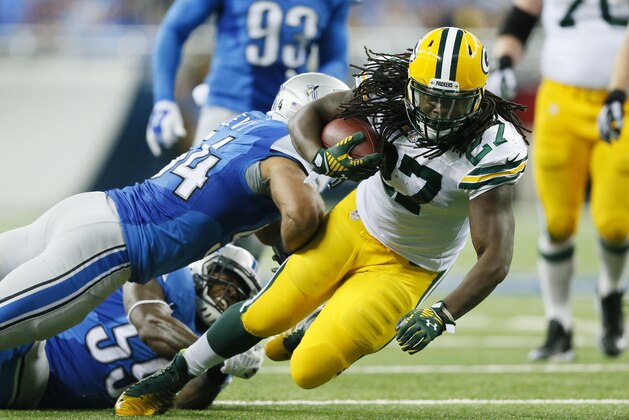 Detroit Lions outside linebacker DeAndre Levy (54) tackles Green Bay Packers running back Eddie Lacy (27) during the second half of an NFL football game in Detroit, Sunday, Sept. 21, 2014. (AP Photo/Rick Osentoski)