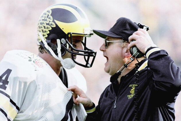 Michigan head coach Bo Schembechler yells at quarterback Jim Harbaugh as the Wolverines fell victim to Arizona State, 22-15, in the Rose Bowl in Pasadena, Jan. 2, 1987. For Schembechler, it was his seventh loss in Rose Bowl action. (AP Photo/Reed Saxon)
