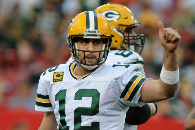 TAMPA, FL - DECEMBER 21: Quarterback Aaron Rodgers #12 of the Green Bay Packers celebrates after a fourth quarter touch down pass against the Tampa Bay Buccaneers at Raymond James Stadium on December 21, 2014 in Tampa, Florida. (Photo by Cliff McBride/Getty Images)
