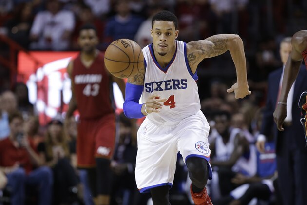 Philadelphia 76ers guard K.J. McDaniels (14) chases a loose ball during the second half of an NBA basketball game against the Miami Heat, Tuesday, Dec. 23, 2014, in Miami. The 76ers defeated the Heat 91-87. (AP Photo/Lynne Sladky)