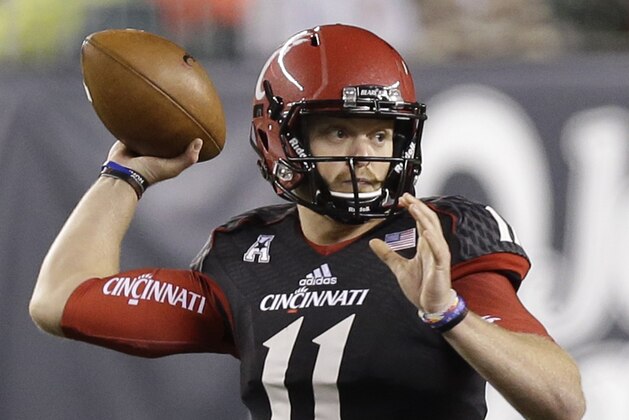 Cincinnati quarterback Gunner Kiel looks to pass against South Florida during the first half of an NCAA college football game, Friday, Oct. 24, 2014, in Cincinnati. (AP Photo/Al Behrman)