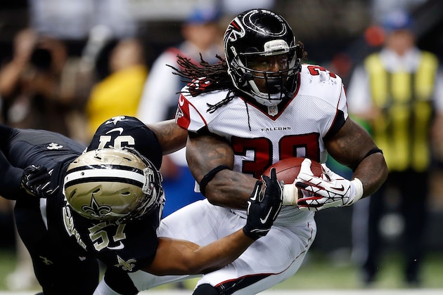 NEW ORLEANS, LA - DECEMBER 21:  Steven Jackson #39 of the Atlanta Falcons is brought down by David Hawthorne #57 of the New Orleans Saints during the first quarter of a game at the Mercedes-Benz Superdome on December 21, 2014 in New Orleans, Louisiana.  (Photo by Sean Gardner/Getty Images)