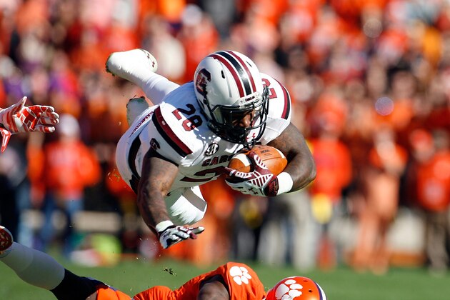 CLEMSON, SC - NOVEMBER 29: Mike Davis #28 of the South Carolina Gamecocks dives for extra yardage during their game against the Clemson Tigers at Memorial Stadium on November 29, 2014 in Clemson, South Carolina. (Photo by Tyler Smith/Getty Images)