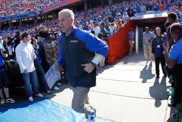 Nov 15, 2014; Gainesville, FL, USA; Florida Gators defensive coordinator D.J. Durkin runs out on the field prior to the game against the South Carolina Gamecocks at Ben Hill Griffin Stadium. Mandatory Credit: Kim Klement-USA TODAY Sports