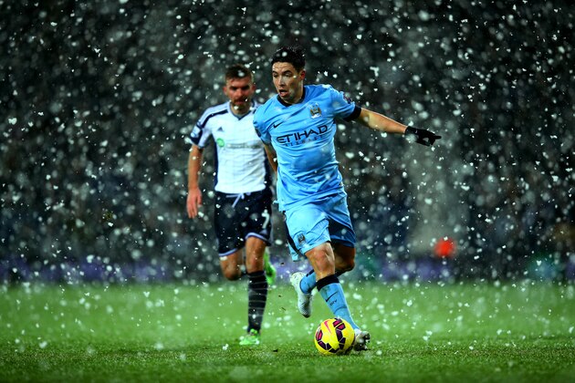 WEST BROMWICH, ENGLAND - DECEMBER 26:  Samir Nasri of Manchester City runs with the ball as snow falls during the Barclays Premier League match between West Bromwich Albion and Manchester City at The Hawthorns on December 26, 2014 in West Bromwich, England.  (Photo by Richard Heathcote/Getty Images)