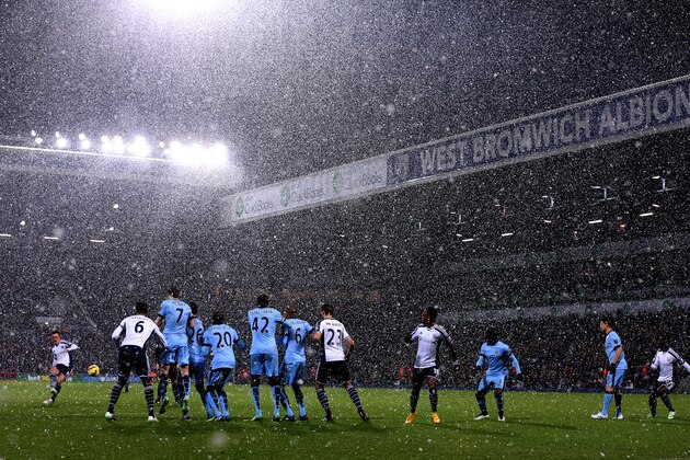 WEST BROMWICH, ENGLAND - DECEMBER 26:  Manchester City players defend a free-kick taken by Craig Gardner of West Brom as snow falls during the Barclays Premier League match between West Bromwich Albion and Manchester City at The Hawthorns on December 26, 2014 in West Bromwich, England.  (Photo by Scott Heavey/Getty Images)