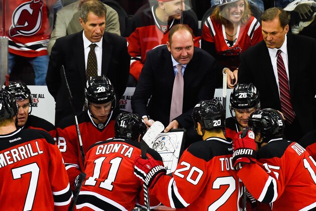NEWARK, NJ - OCTOBER 18: Head coach Peter DeBoer of the New Jersey Devils speaks to his team during a game against the San Jose Sharks at the Prudential Center on October 18, 2014 in Newark, New Jersey.  (Photo by Alex Goodlett/Getty Images)