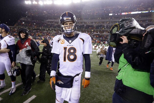 Denver Broncos quarterback Peyton Manning (18) comes off the field after an NFL football game against the Cincinnati Bengals Monday, Dec. 22, 2014, in Cincinnati. Cincinnati won 37-28. (AP Photo/Michael Conroy)