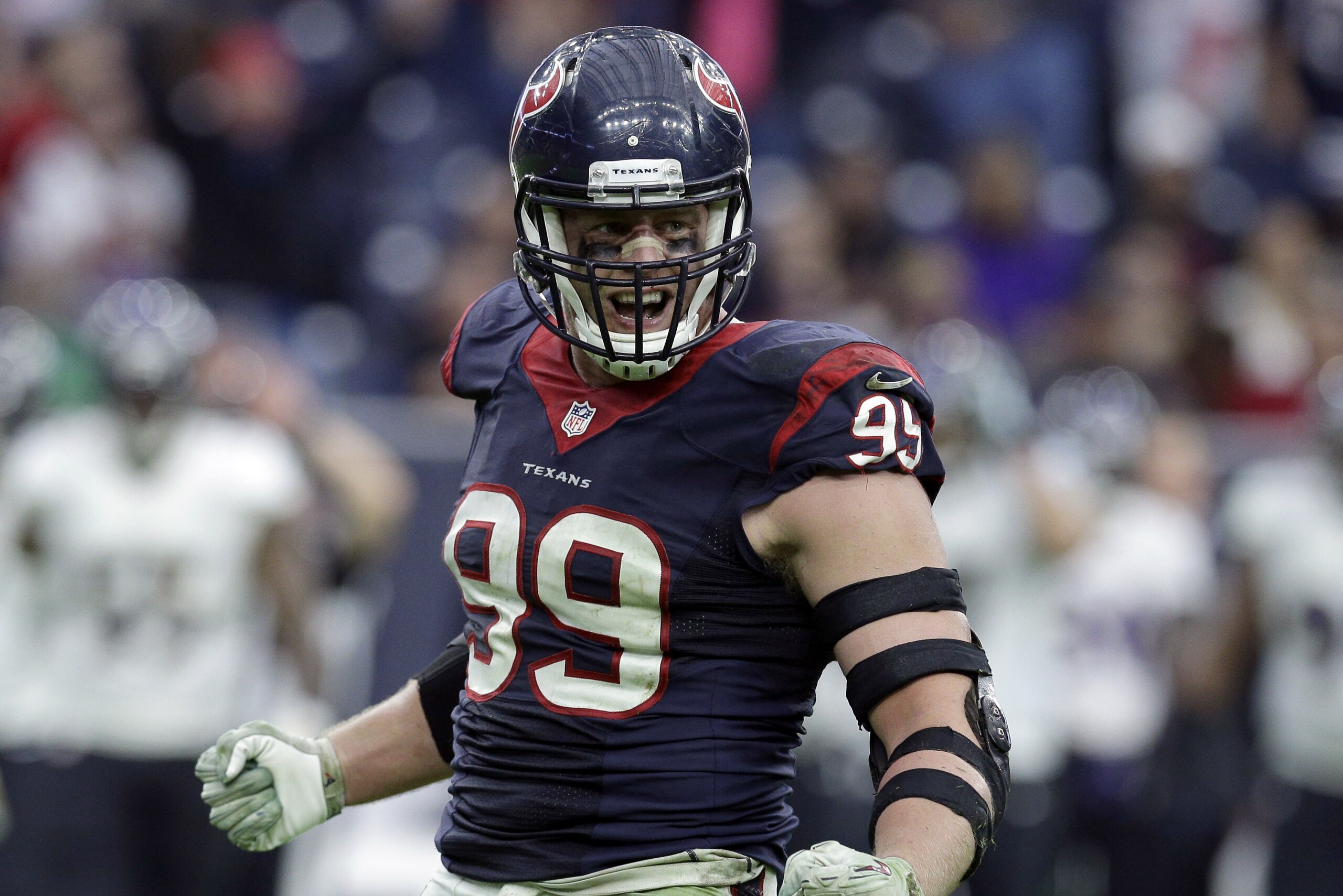 Houston Texans defensive end J.J. Watt (99) celebrates after sacking Baltimore Ravens quarterback Joe Flacco during the second half of an NFL football game Sunday, Dec. 21, 2014, in Houston. (AP Photo/Patric Schneider)
