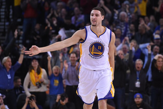 December 18, 2014; Oakland, CA, USA; Golden State Warriors guard Klay Thompson (11) celebrates after a three-point basket during the second quarter against the Oklahoma City Thunder at Oracle Arena. The Warriors defeated the Thunder 114-109. Mandatory Credit: Kyle Terada-USA TODAY Sports