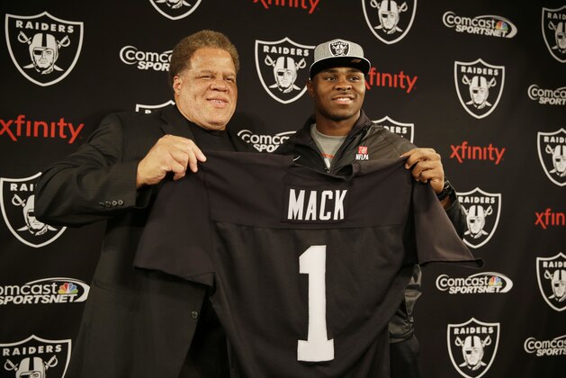 Oakland Raiders first-round draft choice Khalil Mack, right, poses with general manager Reggie McKenzie, left, following a news conference at the team's NFL football headquarters on Friday, May 9, 2014, in Alameda, Calif. Mack, a linebacker, played for Buffalo last season. (AP Photo/Eric Risberg)