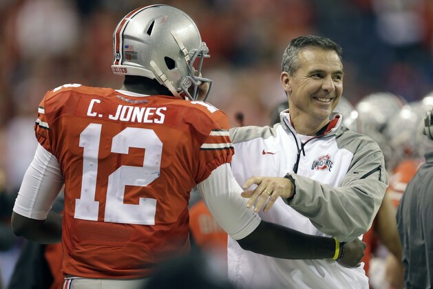 Ohio State head coach Urban Meyer, right, smiles along side quarterback Cardale Jones during the second half of the Big Ten Conference championship NCAA college football game against Wisconsin Saturday, Dec. 6, 2014, in Indianapolis. (AP Photo/Darron Cummings)