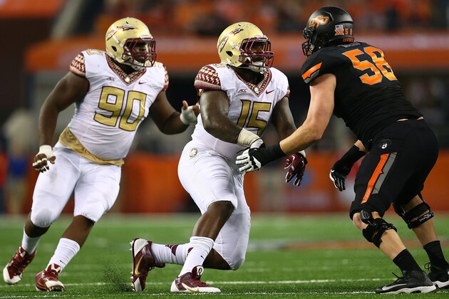 ARLINGTON, TX - AUGUST 30:  Mario Edwards Jr. #15 and Eddie Goldman #90 of the Florida State Seminoles rush as Daniel Koenig #58 of the Oklahoma State Cowboys blocks in the first half of the Advocare Cowboys Classic at AT&T Stadium on August 30, 2014 in Arlington, Texas.  (Photo by Ronald Martinez/Getty Images)