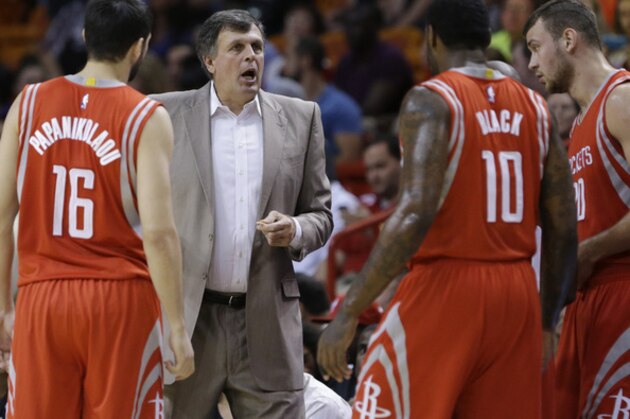 Houston Rockets head coach Kevin McHale, second from left, talks with players forward Kostas Papanikolaou (16) of Greece, forward Tarik Black (10) and forward Donatas Motiejunas of Lithuania, during the first half of a preseason NBA basketball game, Tuesday, Oct. 21, 2014 in Miami. (AP Photo/Wilfredo Lee)