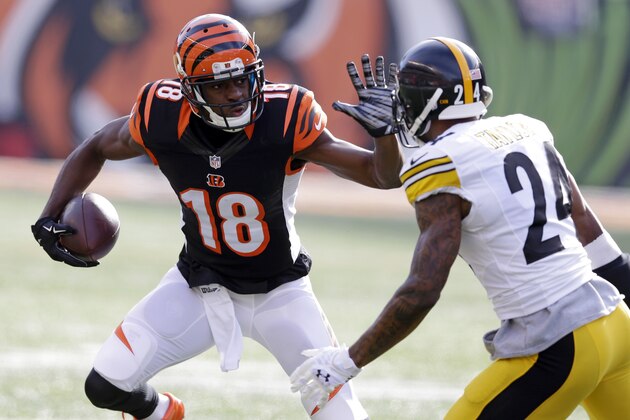 Cincinnati Bengals wide receiver A.J. Green (18) runs against Pittsburgh Steelers cornerback Ike Taylor (24) during the first half of an NFL football game Sunday, Dec. 7, 2014 in Cincinnati. (AP Photo/Michael Conroy)