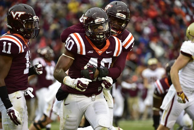 Nov 1, 2014; Blacksburg, VA, USA; Virginia Tech Hokies cornerback Kendall Fuller (11) and linebacker Deon Clarke (40) and defensive end Dadi Nicolas (90) react in the second quarter at Lane Stadium. Mandatory Credit: Bob Donnan-USA TODAY Sports