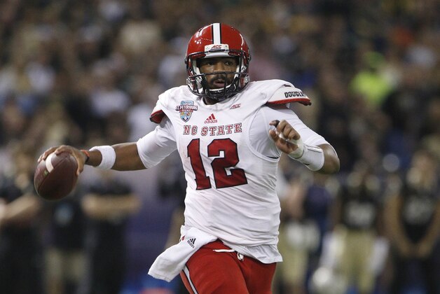 Dec 26, 2014; St. Petersburg, FL, USA; North Carolina State Wolfpack quarterback Jacoby Brissett (12) passes the ball against  the Central Florida Knights during the first half in the 2014 St. Petersburg Bowl at Tropicana Field. Mandatory Credit: Mark Zerof-USA TODAY Sports