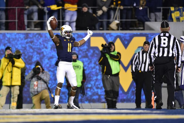 Nov 20, 2014; Morgantown, WV, USA; West Virginia Mountaineers wide receiver Kevin White (11) celebrates in the end zone but the pass was called incomplete after video review in the second quarter at Milan Puskar Stadium. Mandatory Credit: Bob Donnan-USA TODAY Sports