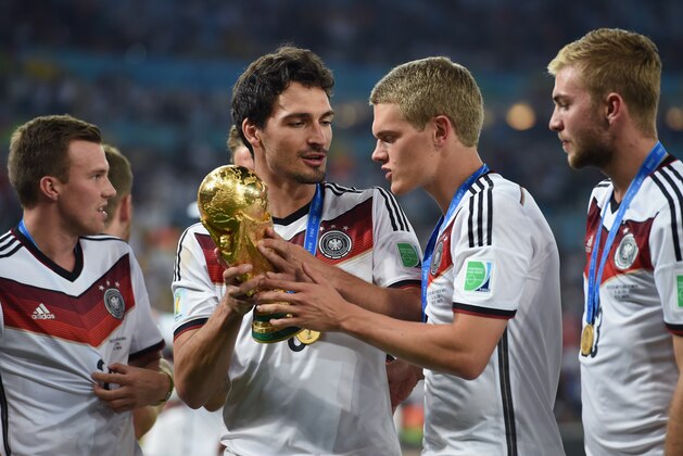 RIO DE JANEIRO, BRAZIL - JULY 13:  Mats Hummels and Matthias Ginter celebrate with the World Cup trophy  after defeating Argentina 1-0 in extra time during the 2014 FIFA World Cup Brazil Final match between Germany and Argentina at Maracana on July 13, 2014 in Rio de Janeiro, Brazil.  (Photo by Matthias Hangst/Getty Images)