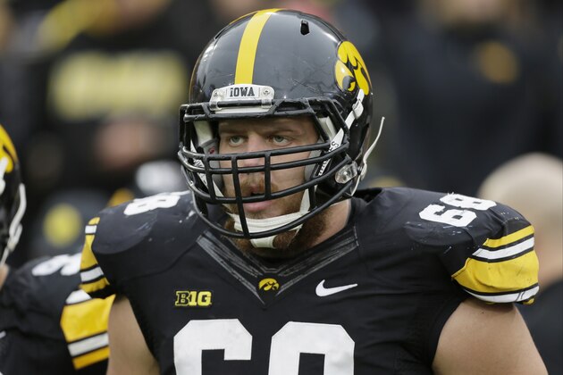 Iowa offensive lineman Brandon Scherff stands on the field during the first half of an NCAA college football game against Wisconsin, Saturday, Nov. 22, 2014, in Iowa City, Iowa. (AP Photo/Charlie Neibergall)
