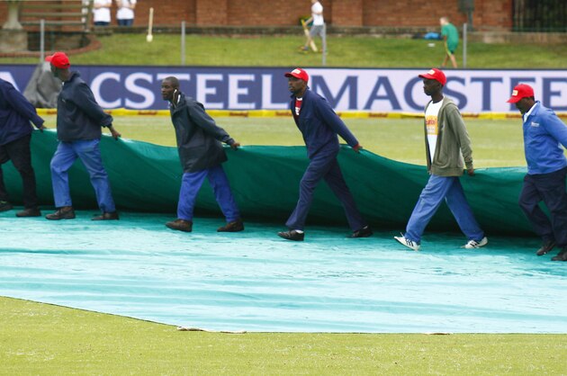 The covers go on during the second day of rain-delayed play on the second test against South Africa  in Port Elizabeth, South Africa, Saturday, Dec. 27, 2014. (AP Photo/Michael Sheehan)