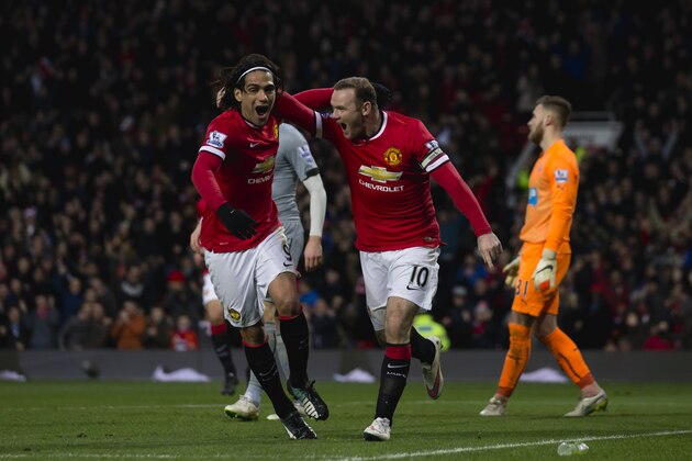 Manchester United's Wayne Rooney, center right, celebrates with teammate Radamel Falcao after scoring during the English Premier League soccer match between Manchester United and Newcastle at Old Trafford Stadium, Manchester, England, Friday, Dec. 26, 2014. (AP Photo/Jon Super)