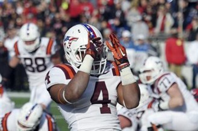 Virginia Tech running back J.C. Coleman (4) celebrates his touchdown during the first half of the Military Bowl NCAA college football game against Cincinnati, Saturday, Dec. 27, 2014, in Annapolis, Md. Virginia Tech won 33-17. (AP Photo/Nick Wass)