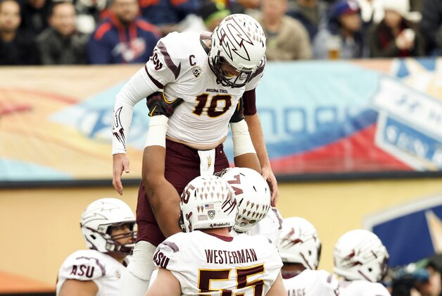 Dec 27, 2014; El Paso, TX, USA; Arizona State Sun Devils quarterback Taylor Kelly (10) celebrates with a teammate after a touchdown against the Duke Blue Devils in the 2014 Sun Bowl at Sun Bowl Stadium. Mandatory Credit: Ivan Pierre Aguirre-USA TODAY Sports