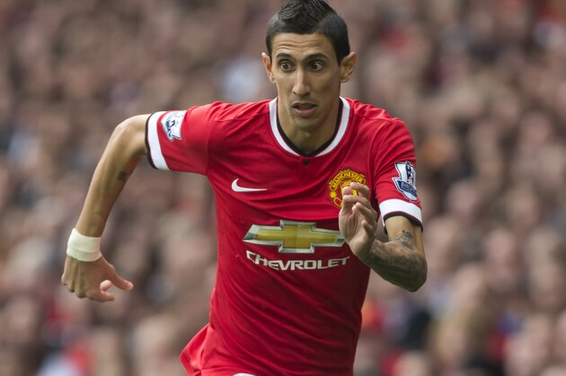 Manchester United's Angel Di Maria controls the ball downfield during their English Premier League soccer match against Queens Park Rangers at Old Trafford Stadium, Manchester, England, Sunday Sept. 14, 2014. (AP Photo/Jon Super)