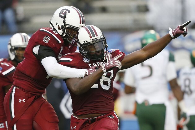 South Carolina linebacker Jonathan Walton (28) celebrates his interception of a Miami pass with Skai Moore, left, in the first half of the Independence Bowl NCAA college football game in Shreveport, La., Saturday, Dec. 27, 2014.(AP Photo/Rogelio V. Solis)