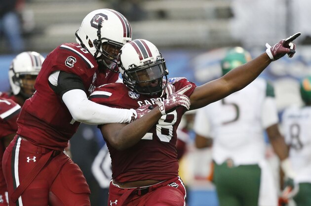 South Carolina linebacker Jonathan Walton (28) celebrates his interception of a Miami pass with Skai Moore, left, in the first half of the Independence Bowl NCAA college football game in Shreveport, La., Saturday, Dec. 27, 2014.(AP Photo/Rogelio V. Solis)