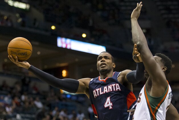 Dec 27, 2014; Milwaukee, WI, USA; Atlanta Hawks forward Paul Millsap (4) shoots around Milwaukee Bucks forward Johnny O'Bryant III (3) during the third quarter at BMO Harris Bradley Center. Mandatory Credit: Jeff Hanisch-USA TODAY Sports