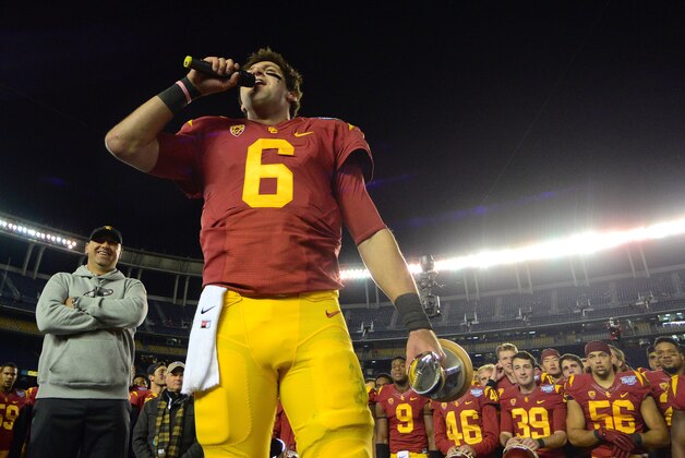 Dec 27, 2014; San Diego, CA, USA; USC Trojans quarterback Cody Kessler (6) speaks to the crowd after being named the game's offensive player of the game as head coach Steve Sarkisian (left) looks on after the Trojans beat the Nebraska Cornhuskers 45-42 in the 2014 Holiday Bowl at Qualcomm Stadium. Mandatory Credit: Jake Roth-USA TODAY Sports
