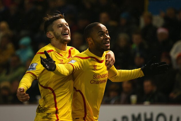 BURNLEY, ENGLAND - DECEMBER 26:  Raheem Sterling (R) of Liverpool celebrates scoring the opening goal with Adam Lallana during the Barclays Premier League match between Burnley and Liverpool at Turf Moor on December 26, 2014 in Burnley, England.  (Photo by Bryn Lennon/Getty Images)