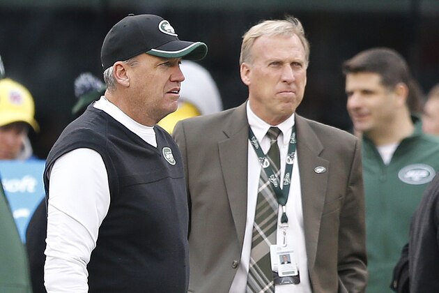 New York Jets head coach Rex Ryan, left, and general manager John Idzik watch their team warm up before and NFL football game against the New England Patriots Sunday, Dec. 21, 2014, in East Rutherford, N.J. (AP Photo/Julio Cortez)
