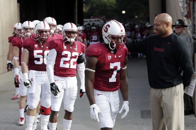 Stanford head coach David Shaw, right, pats wide receiver Ty Montgomery (7) on the head during player introductions during an NCAA college football game against Utah on Saturday, Nov. 15, 2014, in Stanford, Calif. (AP Photo/Marcio Jose Sanchez)