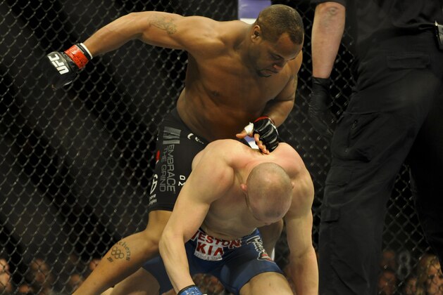 Feb 22, 2014; Las Vegas, NV, USA;  Daniel Cormier (red gloves) tries to land a punch from above on Patrick Cummins (blue gloves) during their UFC light heavyweight bout at Mandalay Bay. Cormier won by way of a TKO in the first round. Mandatory Credit: Stephen R. Sylvanie-USA TODAY Sports