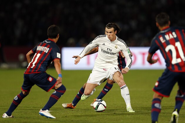 MARRAKECH, MOROCCO - DECEMBER 20: Gareth Bale of Real Madrid CF takes on the San Lorenzo defence during the FIFA Club World Cup Final match between Real Madrid CF and San Lorenzo at Le Grand Stade de Marrakech on December 20, 2014 in Marrakech, Morocco.  (Photo by Steve Bardens/Getty Images)
