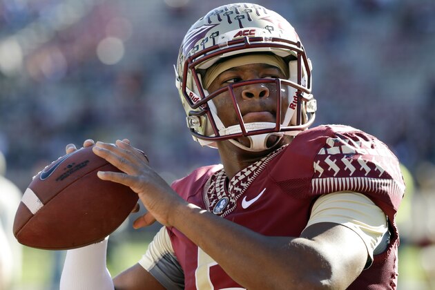 FILE - In this Nov. 29, 2014, file photo, Florida State quarterback Jameis Winston warms up before an NCAA college football game against Florida in Tallahassee, Fla. When Marcus Mariota and second-seeded Oregon face Winston and third-seeded Florida State in the the College Football Playoff semifinal at the Rose Bowl on Jan. 1 it will be the third time Heisman Trophy winners have met in a postseason game. (AP Photo/John Raoux, File)