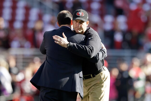 SANTA CLARA, CA - DECEMBER 28:  Head coach Jim Harbaugh of the San Francisco 49ers hugs 49ers CEO Jed York before their game against the Arizona Cardinals at Levi's Stadium on December 28, 2014 in Santa Clara, California.  (Photo by Ezra Shaw/Getty Images)