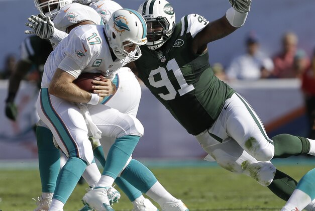 New York Jets defensive end Sheldon Richardson (91) sacks Miami Dolphins quarterback Ryan Tannehill (17) during the first half of an NFL football game, Sunday, Dec. 28, 2014, in Miami Gardens, Fla. (AP Photo/Wilfredo Lee)