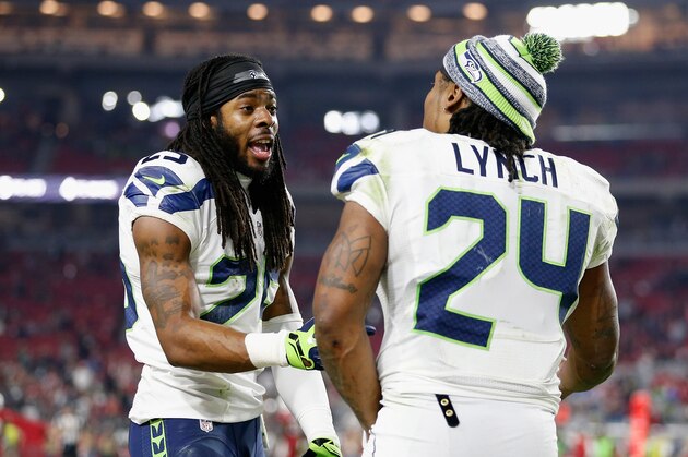 GLENDALE, AZ - DECEMBER 21:  Cornerback Richard Sherman #25 (L) of the Seattle Seahawks talks with running back Marshawn Lynch #24 during the NFL game against the Arizona Cardinals at the University of Phoenix Stadium on December 21, 2014 in Glendale, Arizona.  The Seahawks defeated the Cardinals 35-6.  (Photo by Christian Petersen/Getty Images)