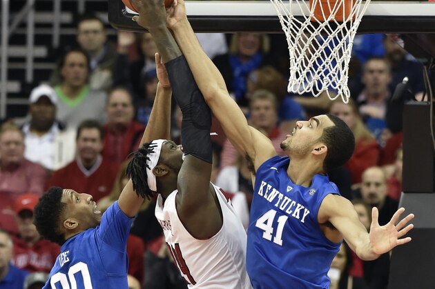 Louisville's Montrezl Harrell, center, has his shot blocked by Kentucky's Trey Lyles, right, during the second half of an NCAA college basketball game, Saturday Dec. 27, 2014, in Louisville, Ky. Kentucky won 58-50. Kentucky's Marcus Lee helps defend on the play. (AP Photo/Timothy D. Easley)